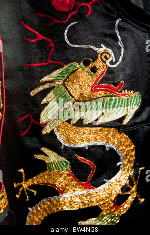 Black, gold and red Chinese embroidered silk garment depicting a dragon, for sale, China Stock Photo