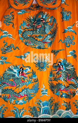 Colourful orange and blue Chinese embroidered silk garment for sale, China Stock Photo