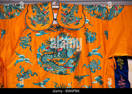 Colourful orange and blue Chinese embroidered silk garment for sale, China Stock Photo