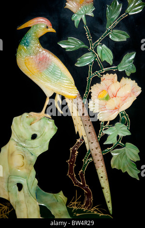 Painted jade carving of a phoenix bird, on a piece of furniture, Beijing, China Stock Photo