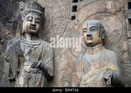 Carved Buddhist statues, Fengxian Temple, Longmen Grottoes and Caves, Luoyang, Henan Province, China. Tang Dynasty Stock Photo