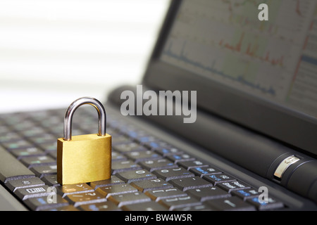 Image of open laptop keyboard with padlock on it Stock Photo