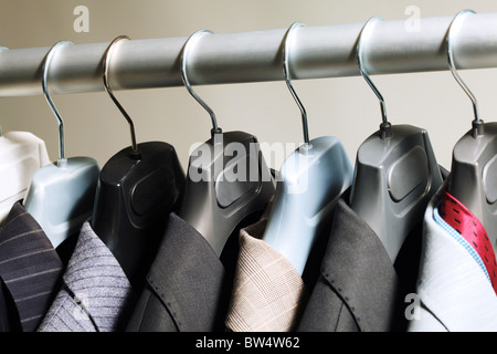 Photo of hangers with jackets on them in boutique Stock Photo