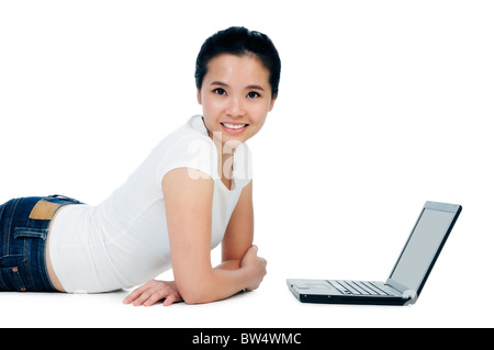 Attractive woman lying on floor with a laptop Stock Photo