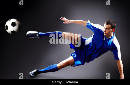 Image of soccer player doing flying kick with ball Stock Photo