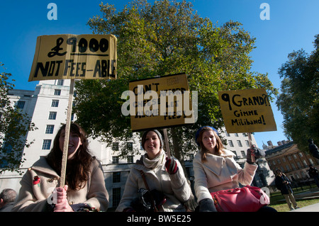 Students and lecturers demonstrate against proposed increase in tuition fees. November 10th 2010.Three students with placards. Stock Photo