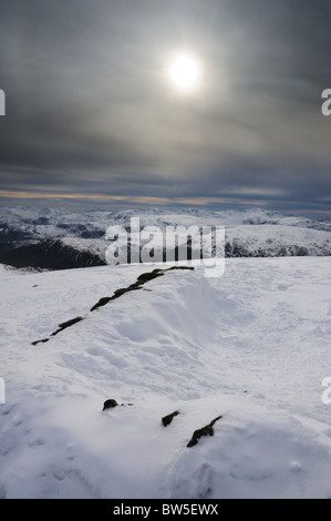 Winter sun and Helvellyn summit shelter, English Lake District Stock Photo
