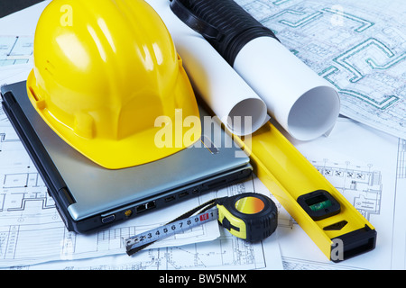 Photo of helmet, laptop, barrel, ruler, drawing scale and architectural project Stock Photo