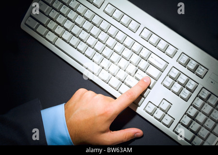 Above view of human finger pressing button- enter Stock Photo