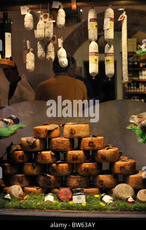 Pecorino cheeses and salami on sale in a shop in Pienza, Siena, Tuscany, Italy Stock Photo