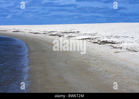 The deep blue sea, golden sandy beach and bright sunny blue skies in Portugal, Europe. Stock Photo