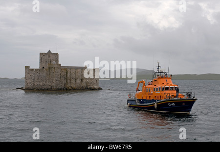 Lifeboat 17-45 'The Duke of Kent' anchored by Kisimul Castle Isle of Barra, Outer Hebrides, Scotland. SCO 7009 Stock Photo