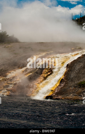 Water from Excelsior Geyser flowing into the Firehole River Stock Photo