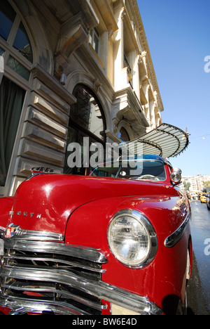 ISTANBUL, TURKEY. A shiny red classic Plymouth automobile parked outside the Pera Palas Hotel in Beyoglu district. Autumn 2010.