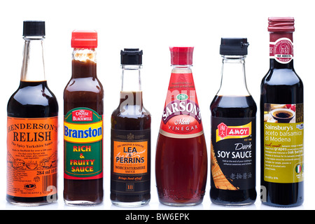 Mixed bottles of sauces and acid vinegars Stock Photo