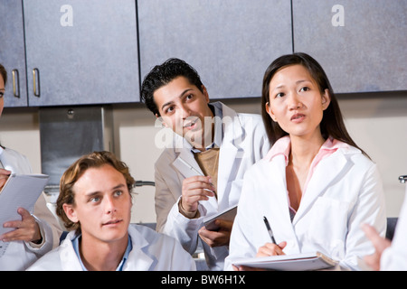 Young doctors in meeting taking notes Stock Photo