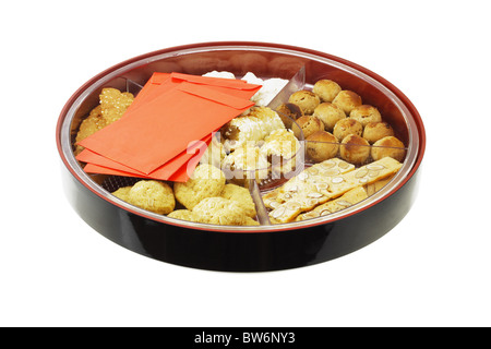 Chinese new year cookies and red packets in gift tray Stock Photo