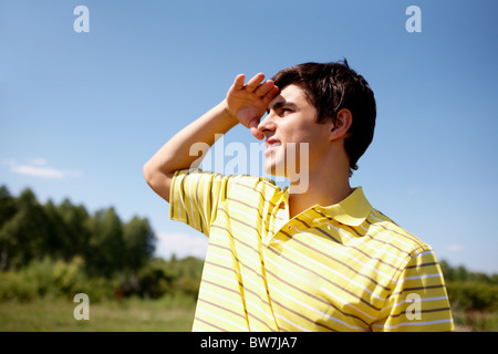 Photo of handsome man holding his hand near the forehead Stock Photo