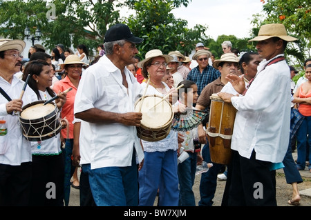 A group of musicians celebrating the Carriage Festival in Pedasi Panama plays during a parade in the street around the plaza. Stock Photo