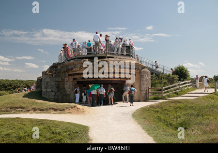 Tourists standing on a German Artillery position at Pointe du Hoc, Omaha Beach, Normandy. Stock Photo