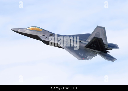 F-22 Raptor plane operated by the US Air Force climbing after take off from RAF Fairford. Aircraft is a Lockheed Martin F-22A Raptor. Stock Photo