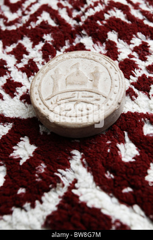 Turba - prayer stone used by Shiite Muslims. Stock Photo