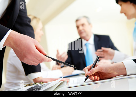 Close-up of business partners hands during discussion in working environment Stock Photo