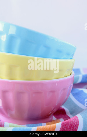 Three colorful cups on each other on a colored background Stock Photo