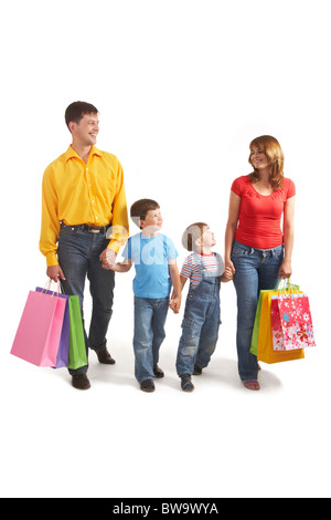 Photo of friendly parents and siblings with bags walking after shopping Stock Photo