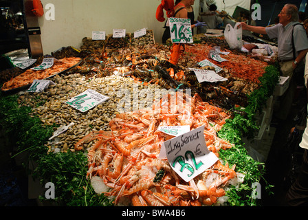 langoustines,mussels, lobster and other fresh seafood on sale at stall in la Boqueria market in Barcelona, Spain Stock Photo