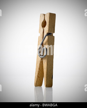 Wooden Clothes Peg on white reflective background Stock Photo