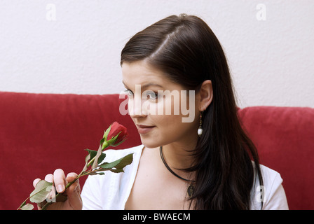 Young woman smelling a rose Stock Photo