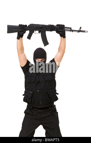 Portrait of armed assassin raising rifle in his hands over white ...
