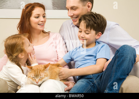 Portrait of affectionate parents and their children enjoying weekend day at home Stock Photo