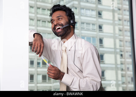 Businessman using telephone headset Stock Photo