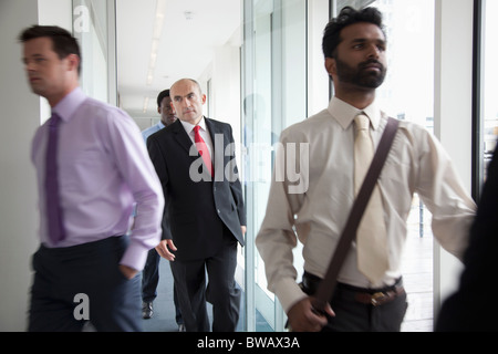 Business people walking fast past camera Stock Photo