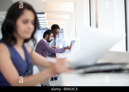 Businessmen using laptop and eating Stock Photo