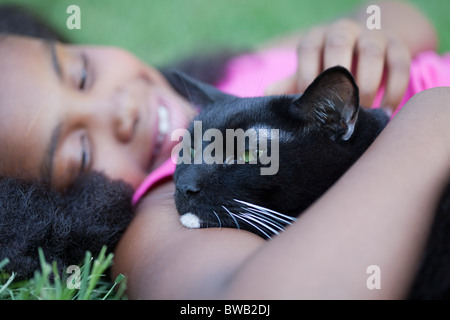 Girl cuddling cat Stock Photo