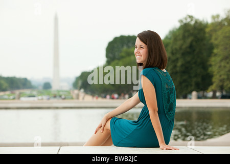 Girl by reflecting pool with washington monument in distance