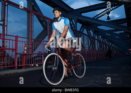 Cyclist riding on bridge Stock Photo