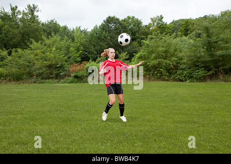 Girl soccer player with ball Stock Photo