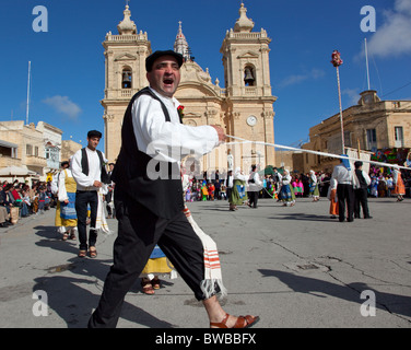 Participant couples performing a medieval dance of gaiety and love and rebellion during Carnival in Gozo in Malta. Stock Photo