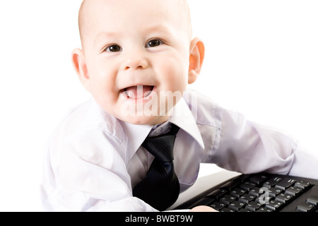Portrait of baby boy wearing shirt and tie looking at camera and laughing