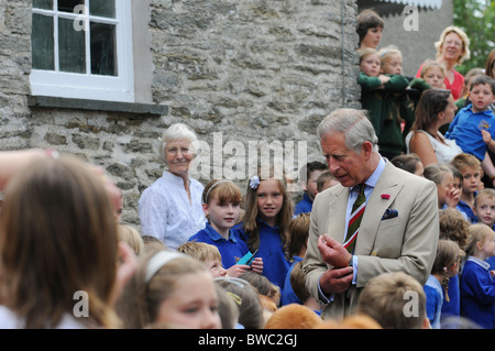 HRH Charles Prince of Wales speaks to school children on a visit to a museum. Stock Photo