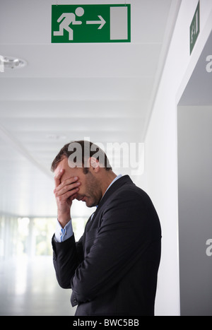 Businessman in empty office, sad Stock Photo