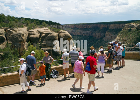 Tourists view cliff dwellings at Mesa Verde National Park located in Montezuma County, Colorado, USA. Stock Photo