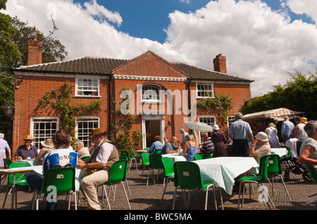 Visitors enjoy refreshments at Redisham Hall open gardens in Redisham , Suffolk , England , Great Britain , Uk Stock Photo