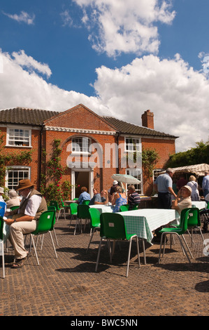 Visitors enjoy refreshments at Redisham Hall open gardens in Redisham , Suffolk , England , Great Britain , Uk Stock Photo