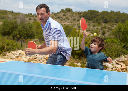 Father and son playing table tennis Stock Photo