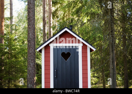 Outhouse in forest Stock Photo